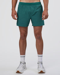 Man wearing Hybrid Lined 5" Short - Transformative Teal | Model:Konnor | Size:M