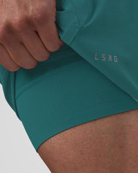 Man wearing Hybrid Lined 5" Short - Transformative Teal | Model:Konnor | Size:M