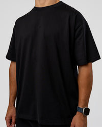 Man wearing MVP 2.0 Oversized Tee - Black | Model:Jaiden | Size:M