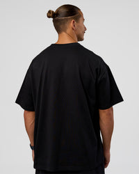 Man wearing MVP 2.0 Oversized Tee - Black | Model:Jaiden | Size:M