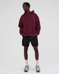 Man wearing MVP Oversized Hoodie - Cherry Lacquer | Model:Okello | Size:M