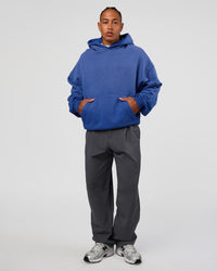 Man wearing Memory In Motion Ultra Heavyweight Washed Hoodie - Electric Indigo Washed | Model:Malebo | Size:M