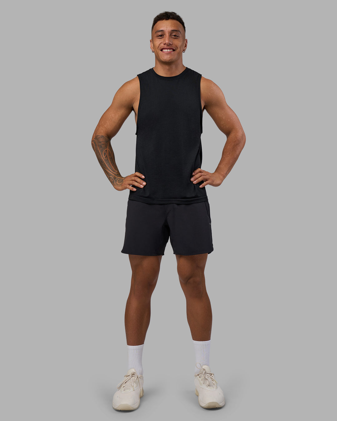 Man wearing AeroFLX+ Seamless Muscle Tank - Black Marl | Model:Daarian | Size:M