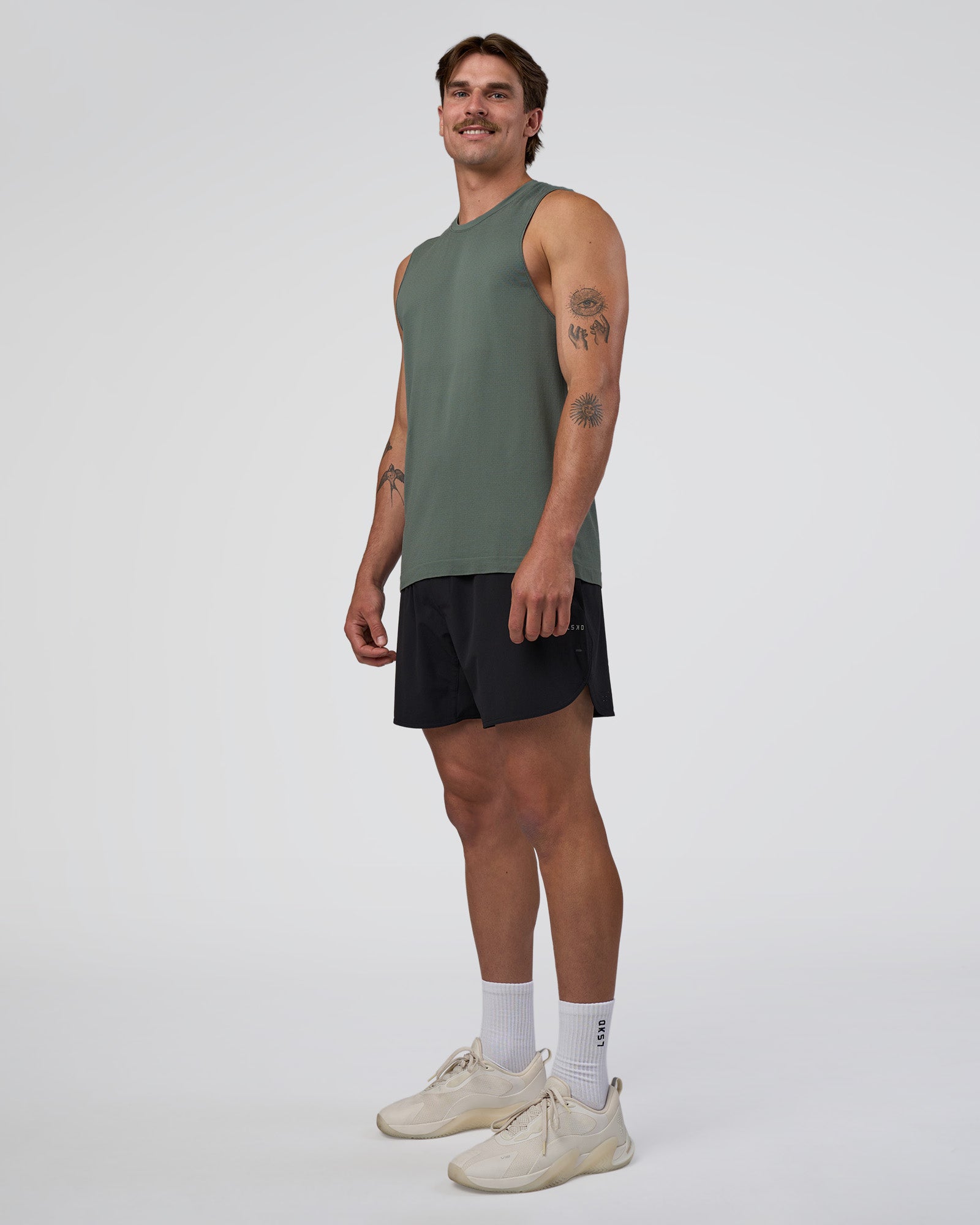 Man wearing AeroFLX+ Seamless Muscle Tank - Graphite/Graphite | Model:Konnor | Size:M