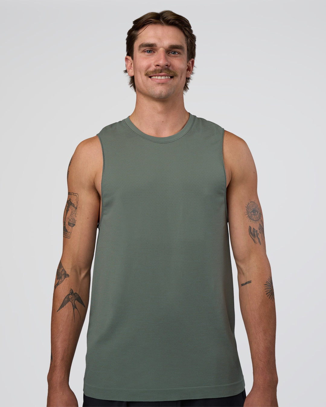 Man wearing AeroFLX+ Seamless Muscle Tank - Graphite/Graphite | Model:Konnor | Size:M