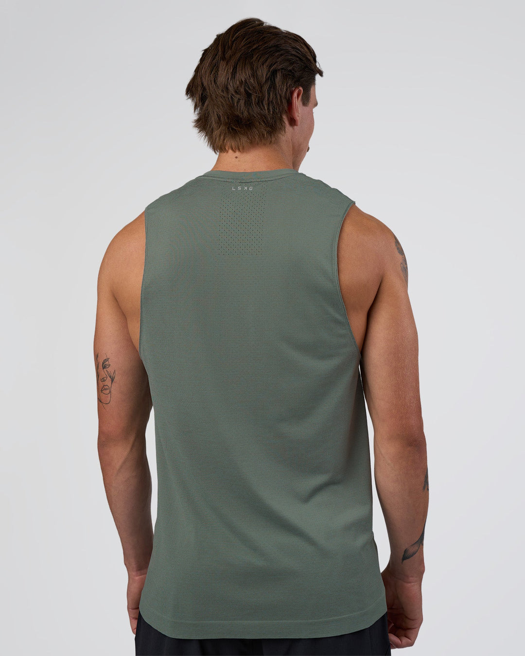 Man wearing AeroFLX+ Seamless Muscle Tank - Graphite/Graphite | Model:Konnor | Size:M