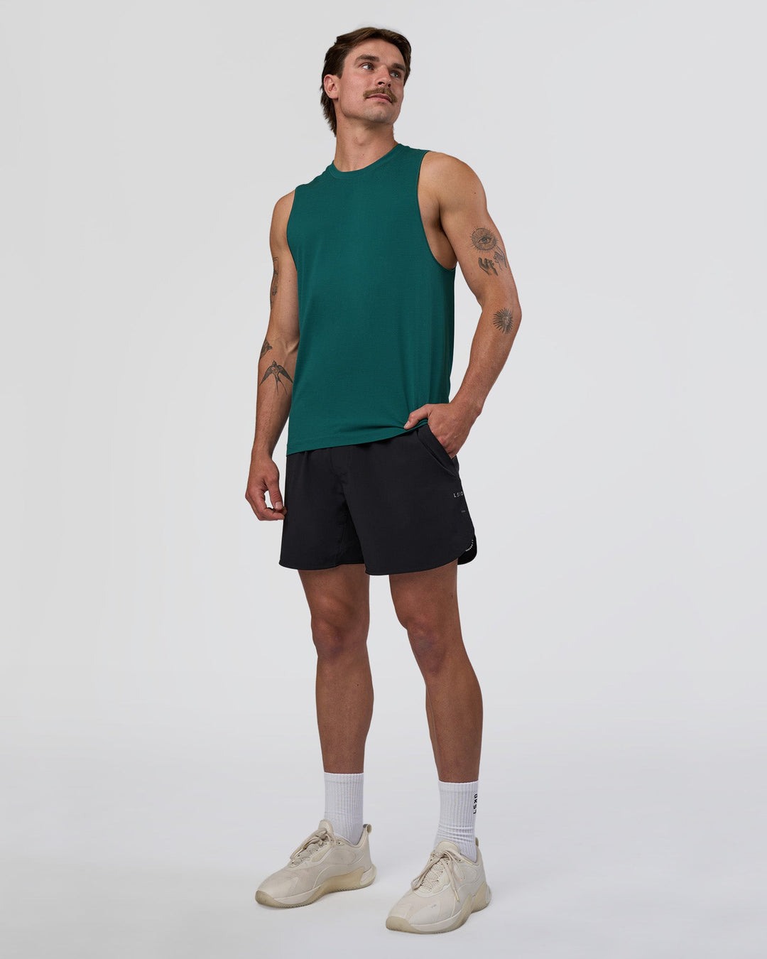 Man wearing AeroFLX+ Seamless Muscle Tank - Transformative Teal/Transformative Teal | Model:Konnor | Size:M