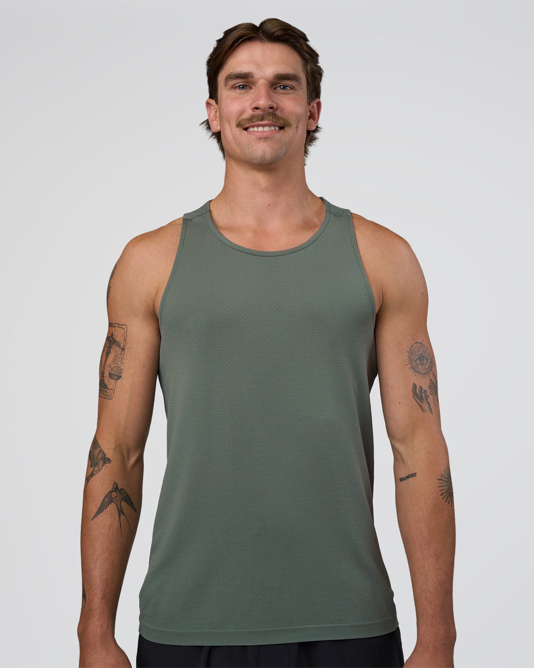 Man wearing AeroFLX+ Seamless Tank - Graphite/Graphite | Model:Konnor | Size:M