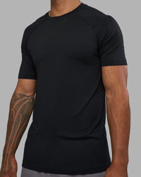 Man wearing AeroFLX+ Seamless Tee - Black Marl | Model:Daarian | Size:M