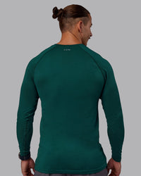 Man wearing AeroFLX+ Seamless Long Sleeve Tee - Dark Moss/Dark Moss | Model:Jaiden | Size:M