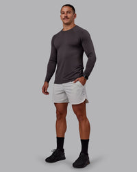 Man wearing AeroFLX+ Seamless Long Sleeve Tee - Dark Storm/Dark Storm | Model:Jaiden | Size:M