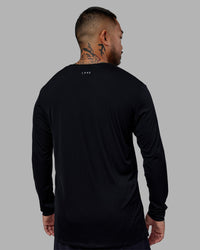 Man wearing Pace Running Long Sleeve Top - Black | Model:Justin | Size:M
