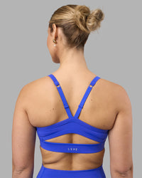 Woman wearing Momentum Sports Bra - Power Cobalt | Model:Amy | Size:M