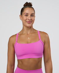 Woman wearing Momentum Sports Bra - Ultra Fuchsia | Model:Abbey | Size:M