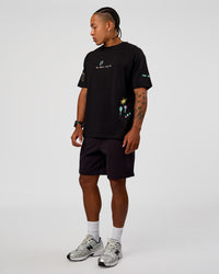 Man wearing Mother's Day FLXCotton Oversize Tee - Black | Model:Malebo | Size:M