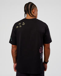 Man wearing Mother's Day FLXCotton Oversize Tee - Black | Model:Malebo | Size:M