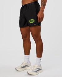 Man wearing Pace 5" Lined Running Short - Black-Lime Glo Indigo | Model:Malebo | Size:M