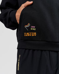 Man wearing Pride Sticker Boxy Hoodie - Black | Model:Albert | Size:M