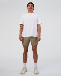 Man wearing Rep 5" Performance Short - Greige | Model:Konnor | Size:M