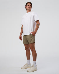 Man wearing Rep 5" Performance Short - Greige | Model:Konnor | Size:M