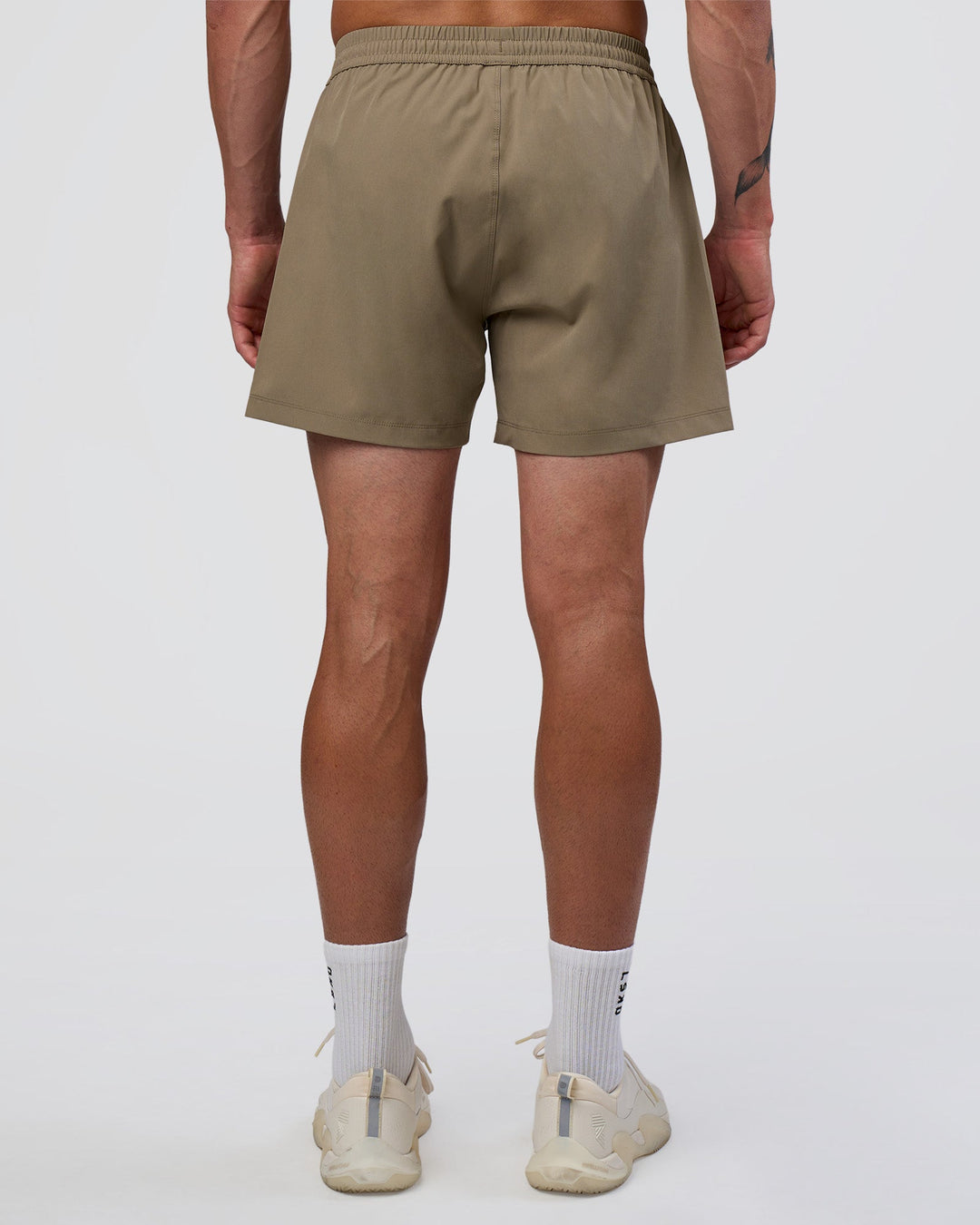 Man wearing Rep 5" Performance Short - Greige | Model:Konnor | Size:M