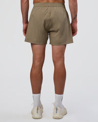 Man wearing Rep 5" Performance Short - Greige | Model:Konnor | Size:M
