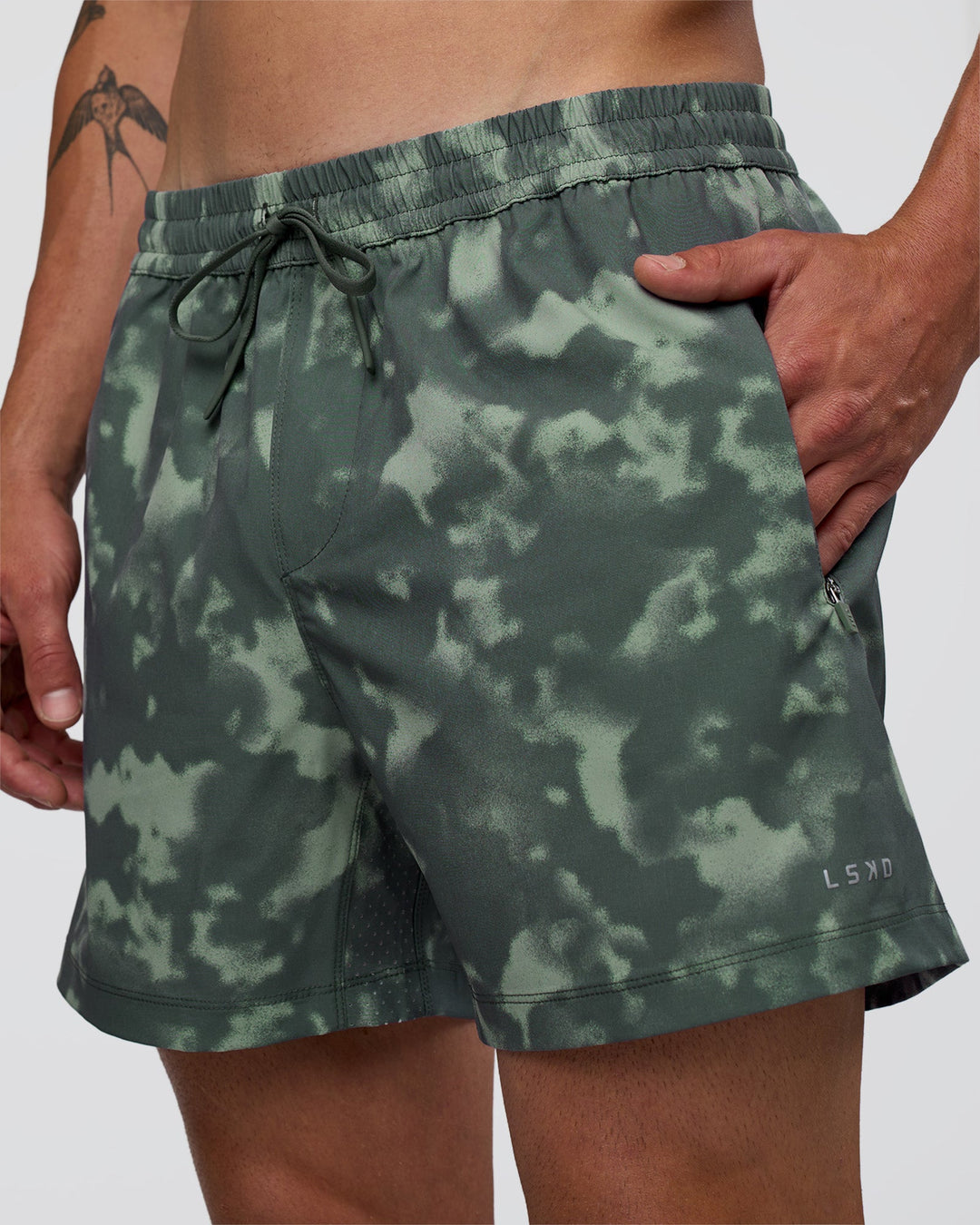 Man wearing Rep 5" Performance Short - Washed Camo Carbon | Model:Konnor | Size:M