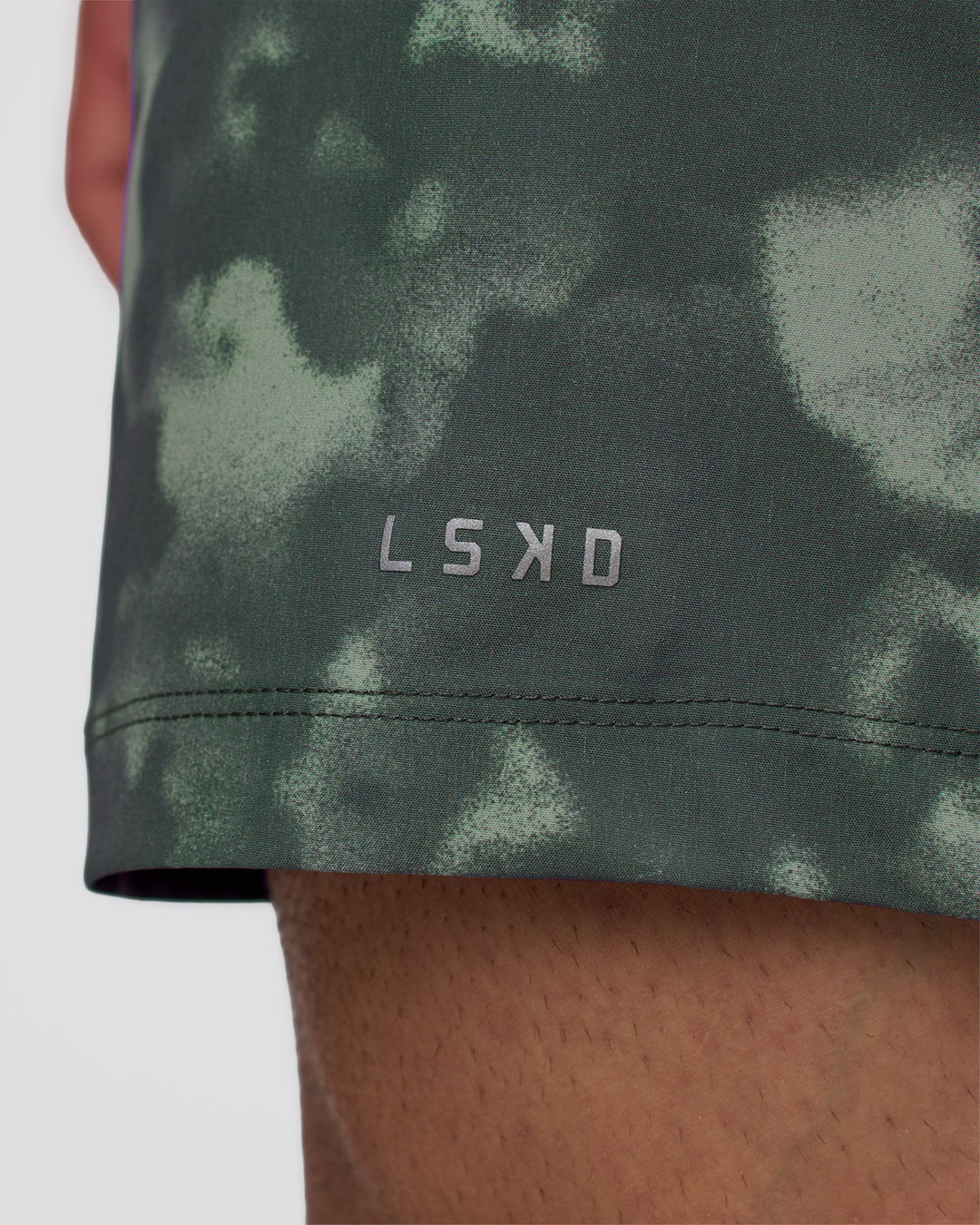 Man wearing Rep 5" Performance Short - Washed Camo Carbon | Model:Konnor | Size:M