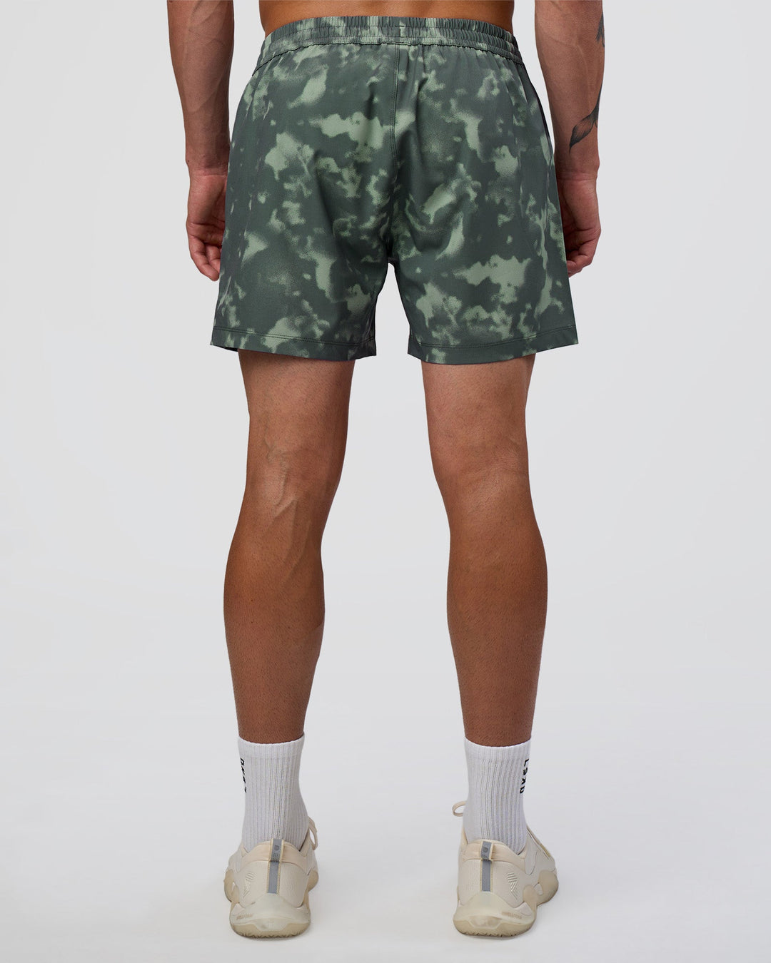 Man wearing Rep 5" Performance Short - Washed Camo Carbon | Model:Konnor | Size:M
