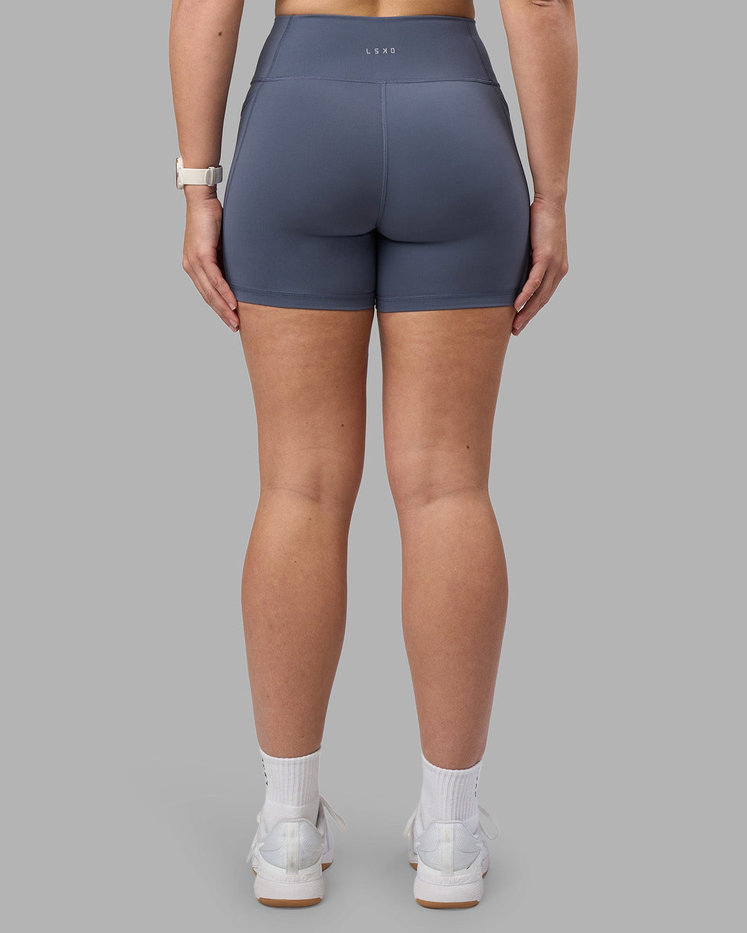 Woman wearing Rep Ultra High-Rise 4&quot; Short Pockets - Night Shadow-White | Model:Amy | Size:M