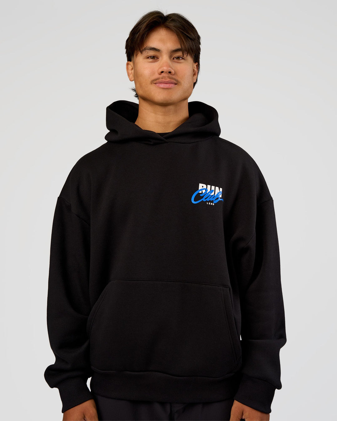 Man wearing Run Club Script Oversized Hoodie - Black-Palace Blue | Model:George | Size:M