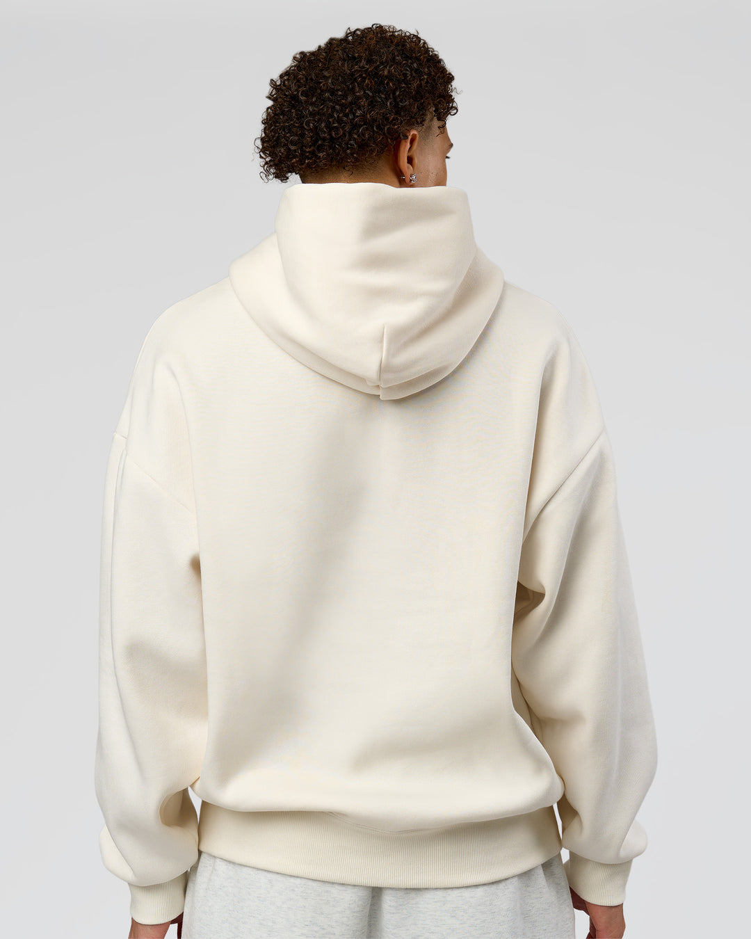 Man wearing Shadow Mode Oversized Hoodie - Off White | Model:Leandro | Size:M