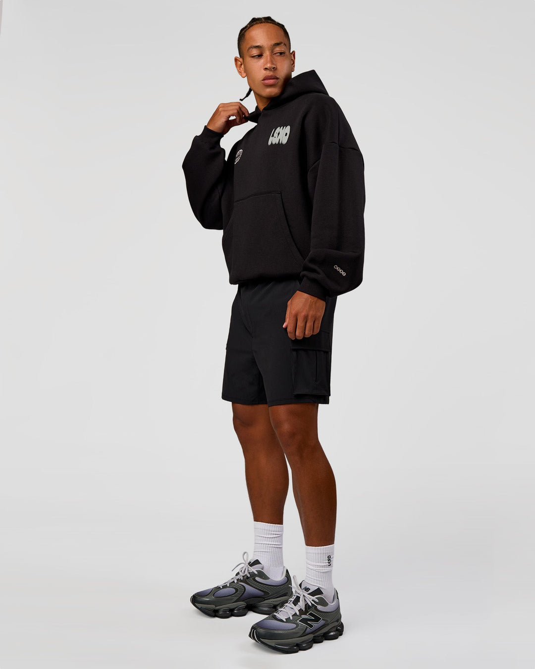 Man wearing Static Grit Unisex Boxy Hoodie - Black-Alloy | Model:Malebo | Size:M