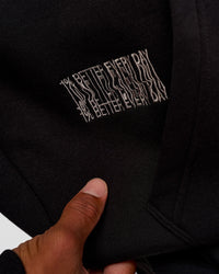 Man wearing Static Grit Unisex Boxy Hoodie - Black-Alloy | Model:Malebo | Size:M