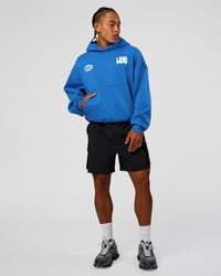 Man wearing Static Grit Unisex Boxy Hoodie - Palace Blue-White | Model:Malebo | Size:M
