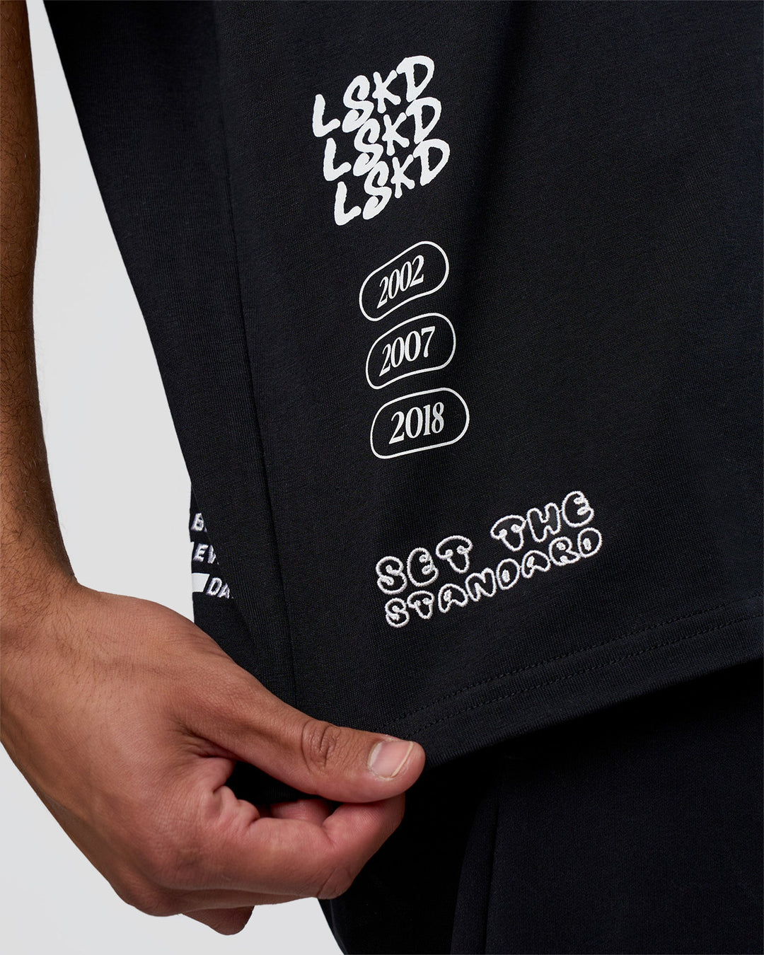 Man wearing Sticker Heavyweight Oversized Tee - Black-White | Model:Zoran | Size:M