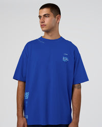 Man wearing Sticker Heavyweight Oversized Tee - Electric Indigo-Baltic Sea | Model:Zoran | Size:M