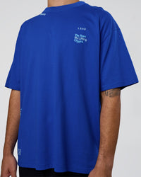 Man wearing Sticker Heavyweight Oversized Tee - Electric Indigo-Baltic Sea | Model:Zoran | Size:M