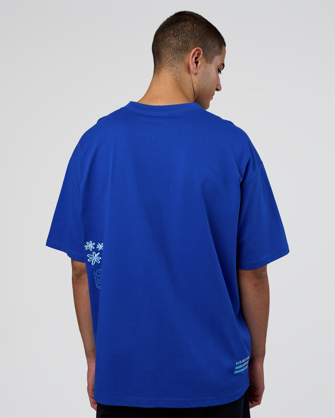 Man wearing Sticker Heavyweight Oversized Tee - Electric Indigo-Baltic Sea | Model:Zoran | Size:M