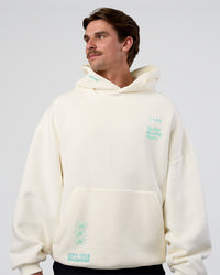 Man wearing Sticker Unisex Oversized Hoodie - Off White-Jelly Mint | Model:Konnor | Size:M