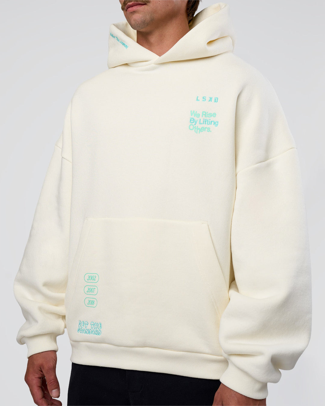 Man wearing Sticker Unisex Oversized Hoodie - Off White-Jelly Mint | Model:Konnor | Size:M