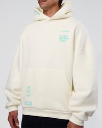 Man wearing Sticker Unisex Oversized Hoodie - Off White-Jelly Mint | Model:Konnor | Size:M