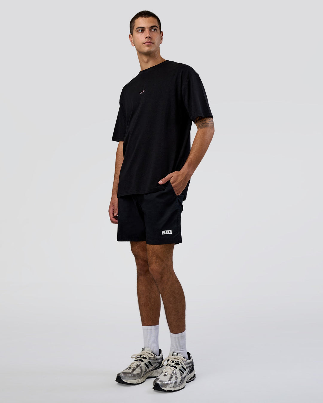 Man wearing Together We Rise FLXCotton Oversized Tee - Black-Candy Pink | Model:Zoran | Size:M