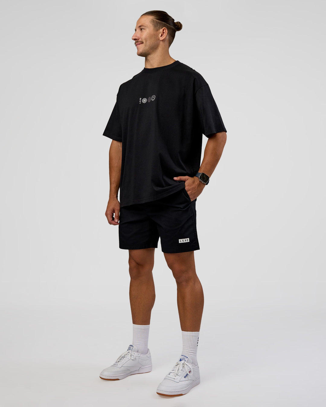 Man wearing Trust The Process Heavyweight Unisex Oversized Tee - Black-White | Model:Jaiden | Size:M