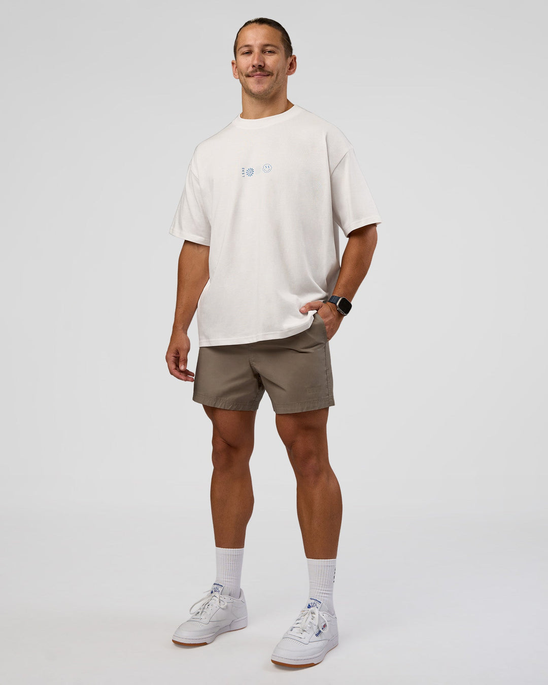 Man wearing Trust The Process Heavyweight Unisex Oversized Tee - Off White-Electric Indigo | Model:Jaiden | Size:M