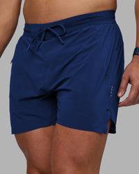 Man wearing UltraAir 5" Lined Performance Short - Midnight Blue | Model:Jaiden | Size:M