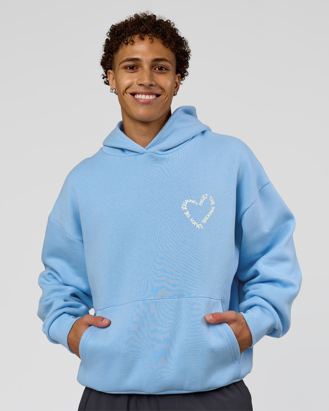 Man wearing Unisex Love The Process Oversize Hoodie - Open Air-Off White | Model:Leandro | Size:M