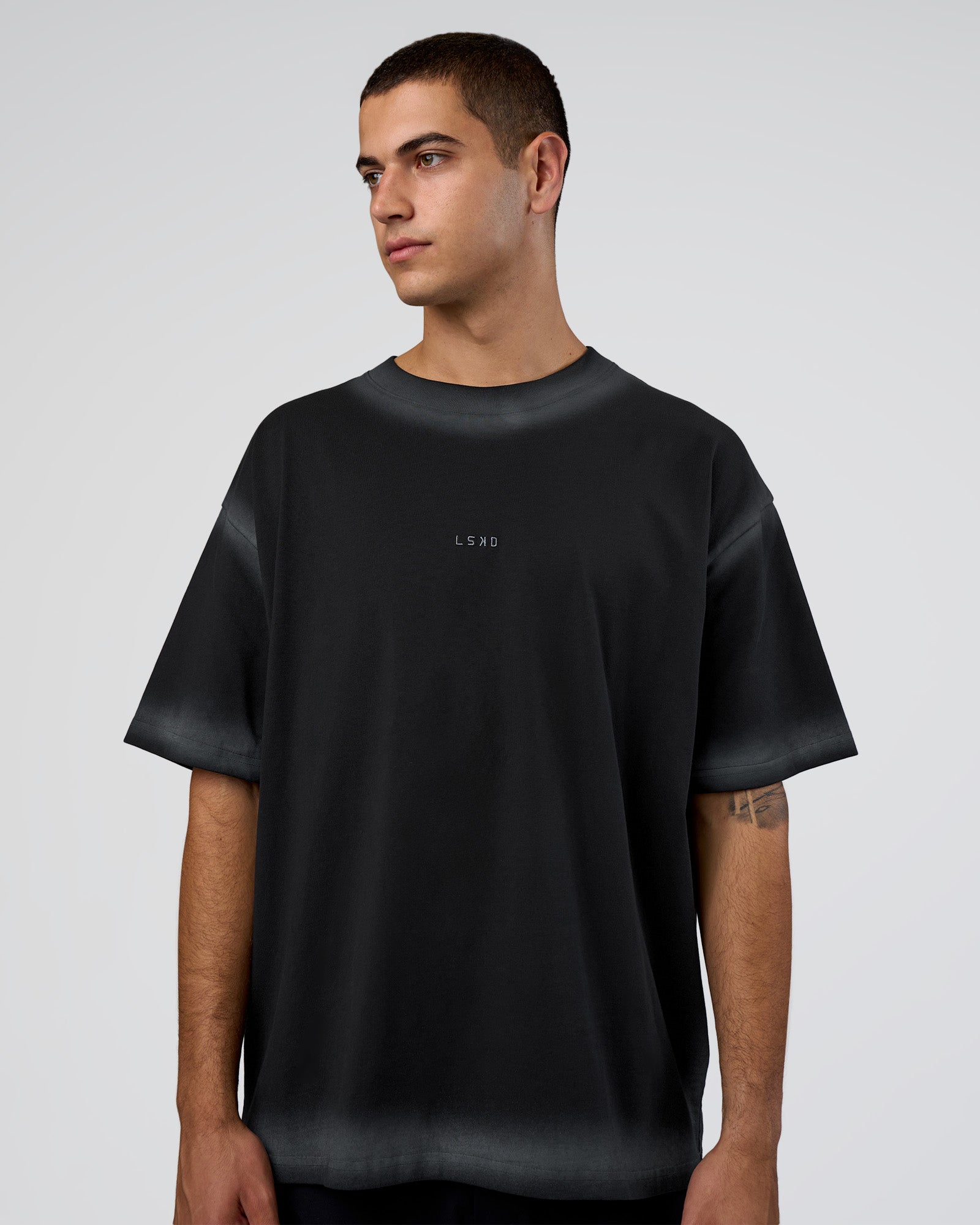 Man wearing Urban Blur Heavyweight Unisex Oversized Tee - Black-Dark Storm | Model:Zoran | Size:M