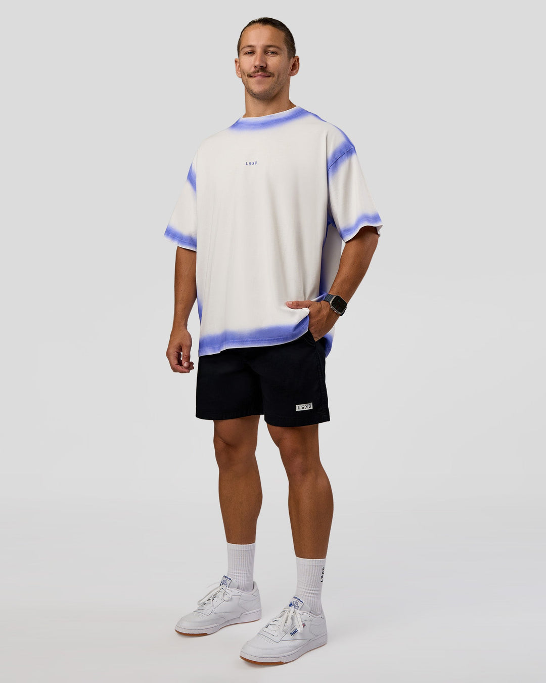 Man wearing Urban Blur Heavyweight Unisex Oversized Tee - Off White-Power Cobalt | Model:Jaiden | Size:M