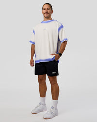Man wearing Urban Blur Heavyweight Unisex Oversized Tee - Off White-Power Cobalt | Model:Jaiden | Size:M